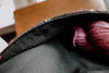 A close up of the precise stitching along the pocket of the bag, showing where the flannel joins with the black canvas.